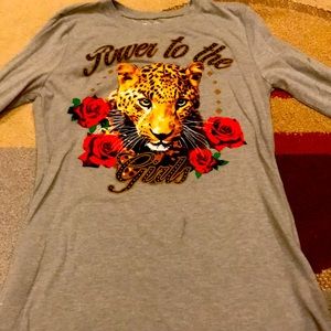 A green shirt with a tiger on it